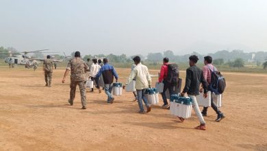 हेलीपेड की ओर जाते कर्मी